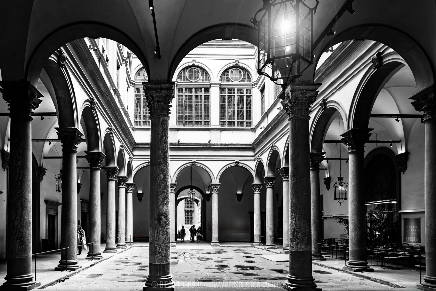 Renaissance palazzo courtyard with stone columns and arches in Florence, Italy, black and white travel photography by Diego Torroija