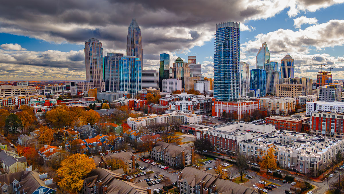 Aerial drone view of the Charlotte skyline and surrounding neighborhoods in fall