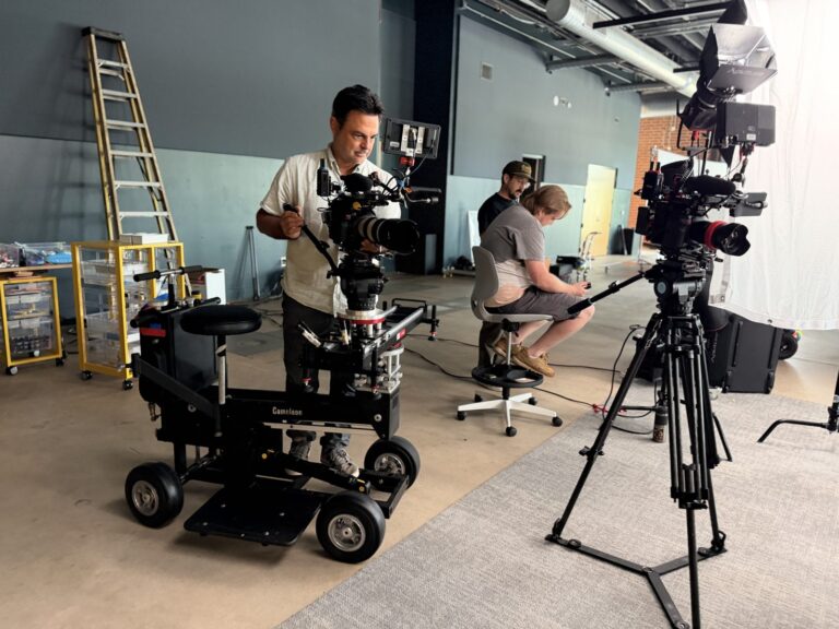 Crew prepping a Cameleon dolly and cinema camera before a take